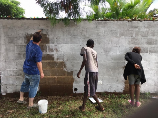 White washing a wall whilst volunteering in Africa